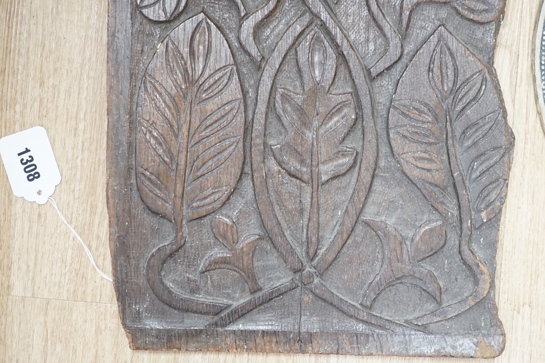 An 18th century carved oak panel together with a commemorative rounded ‘presented by the British and foreign school society to Florence Edith May, pupil in Stockwell College Practicing School to commemorate the completio